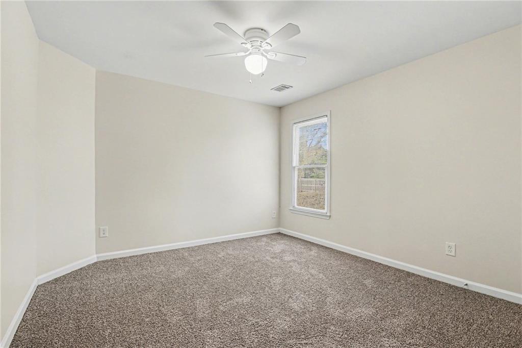7170 Threadstone Overlook Duluth, GA 30097 - Photo 15 of 26 an empty room with chandelier fan and windows