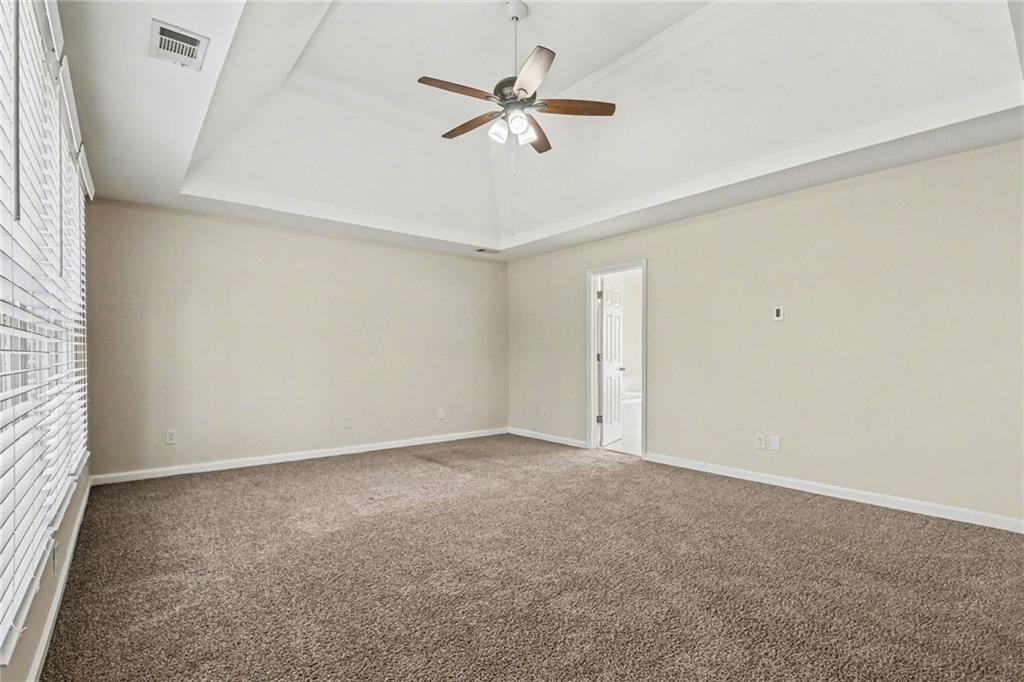7170 Threadstone Overlook Duluth, GA 30097 - Photo 18 of 26 an empty room with a ceiling fan and a window
