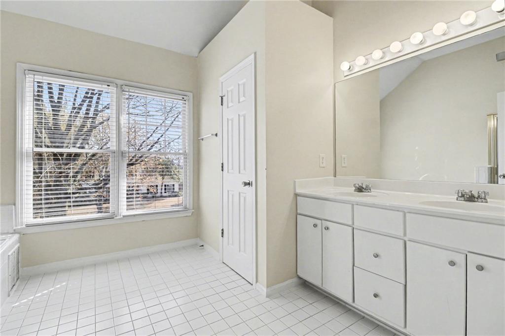 7170 Threadstone Overlook Duluth, GA 30097 - Photo 20 of 26 a spacious bathroom with double vanity and a mirror