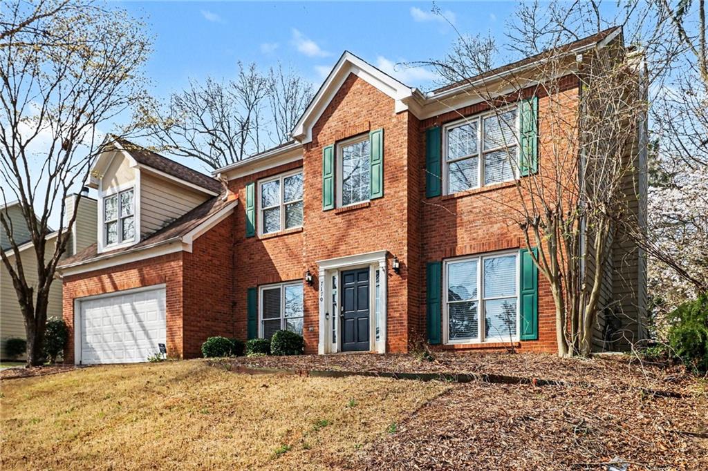 7170 Threadstone Overlook Duluth, GA 30097 - Photo 2 of 26 a front view of a house with a yard