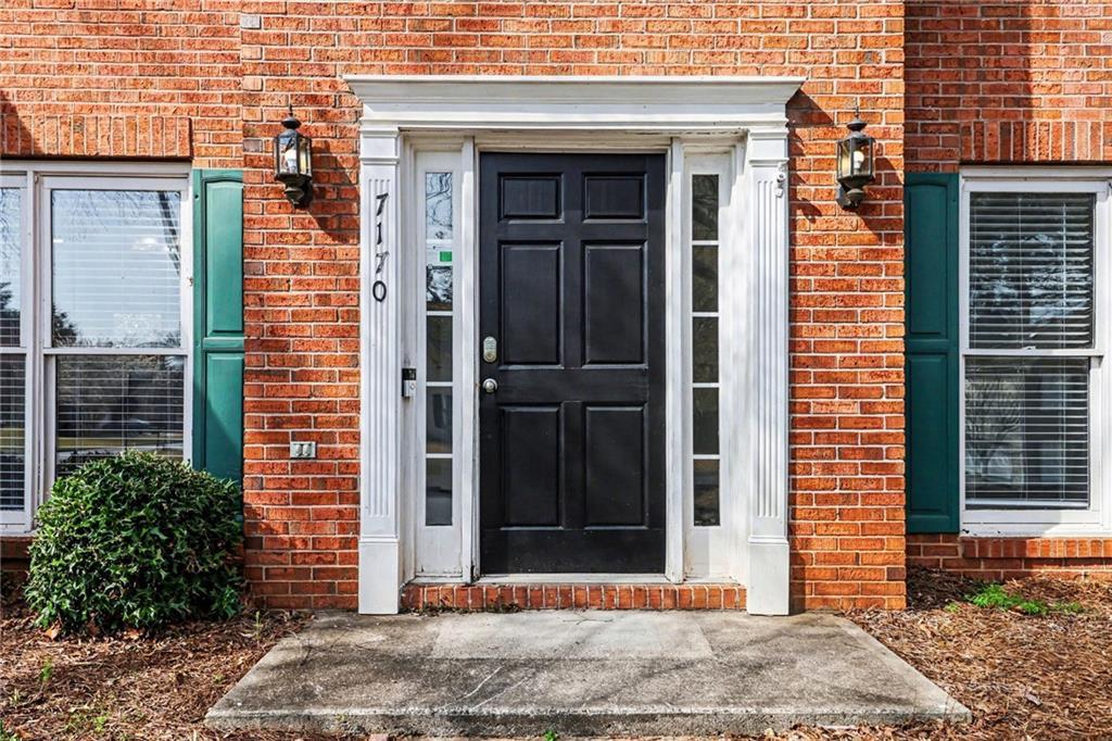 7170 Threadstone Overlook Duluth, GA 30097 - Photo 3 of 26 a view of a brick house with windows