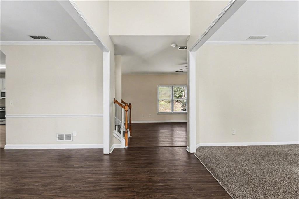 7170 Threadstone Overlook Duluth, GA 30097 - Photo 6 of 26 a view of an empty room with wooden floor and a window