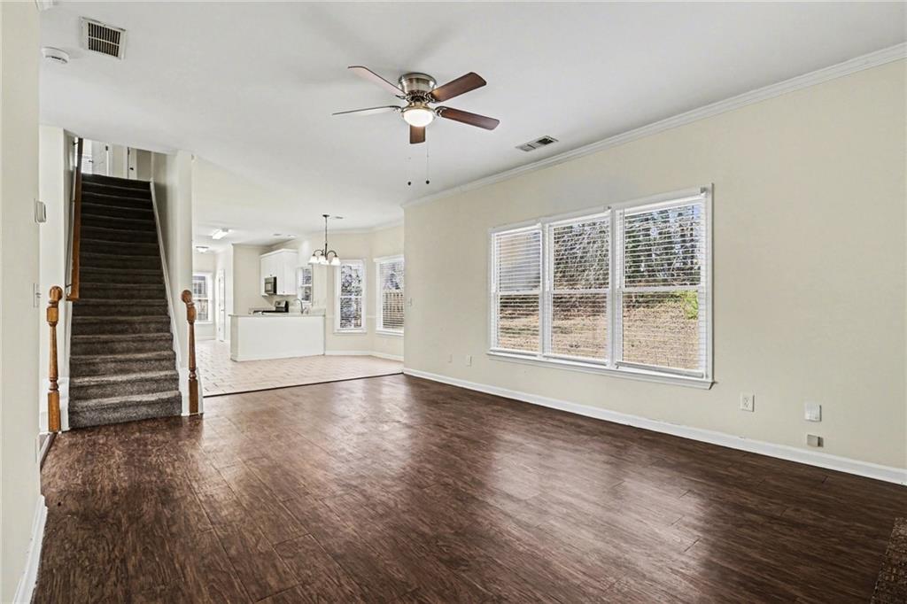 7170 Threadstone Overlook Duluth, GA 30097 - Photo 7 of 26 a view of an empty room with wooden floor and a window