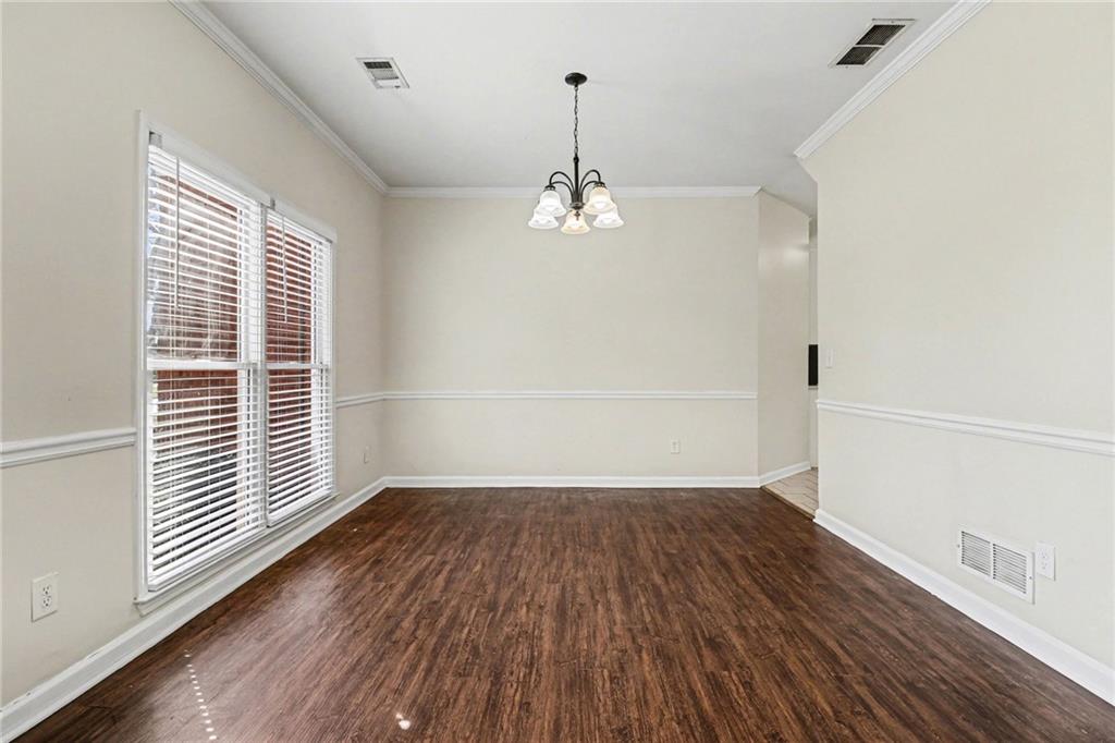 7170 Threadstone Overlook Duluth, GA 30097 - Photo 8 of 26 an empty room with wooden floor and windows
