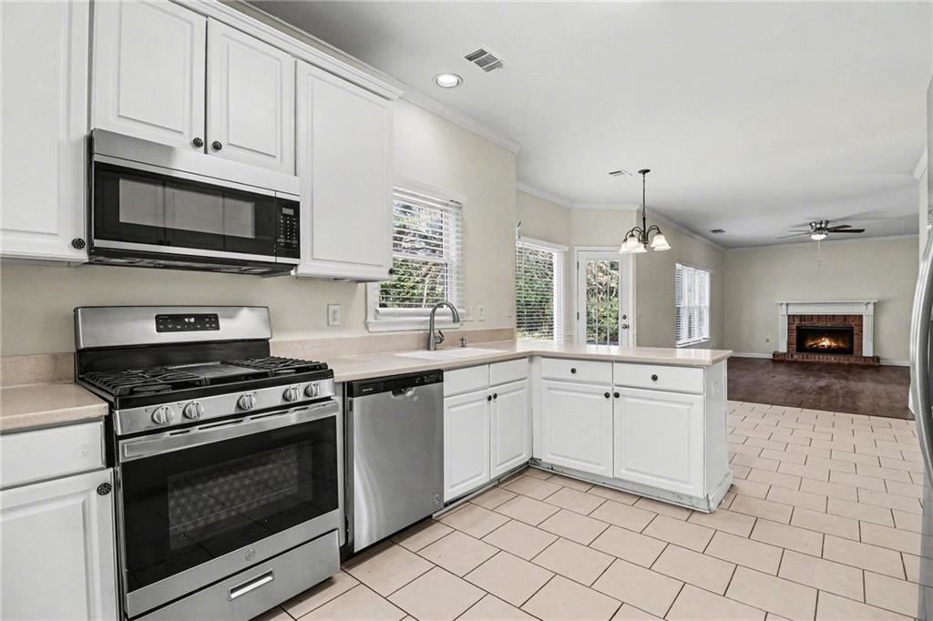 7170 Threadstone Overlook Duluth, GA 30097 - Photo 9 of 26 a large kitchen with cabinets stainless steel appliances and a sink