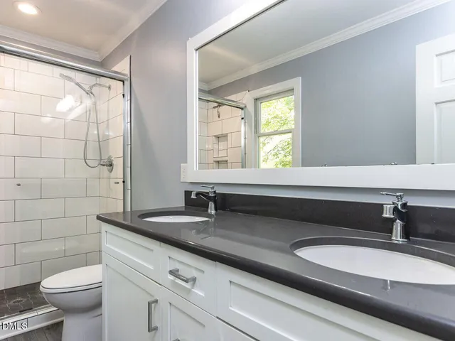 an empty room with a window and ceiling fan