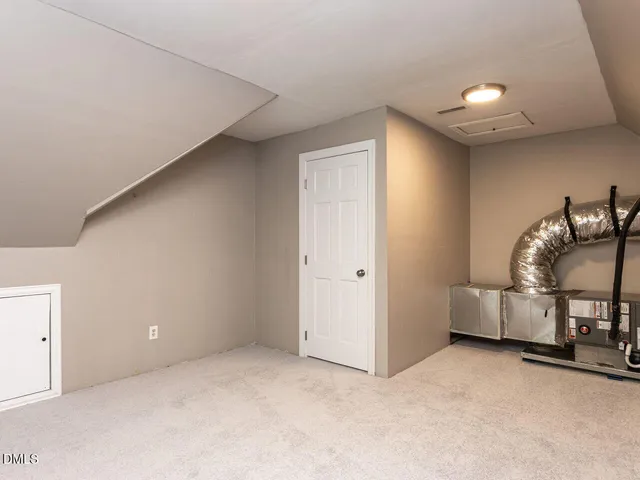 an empty room with a ceiling fan and a window