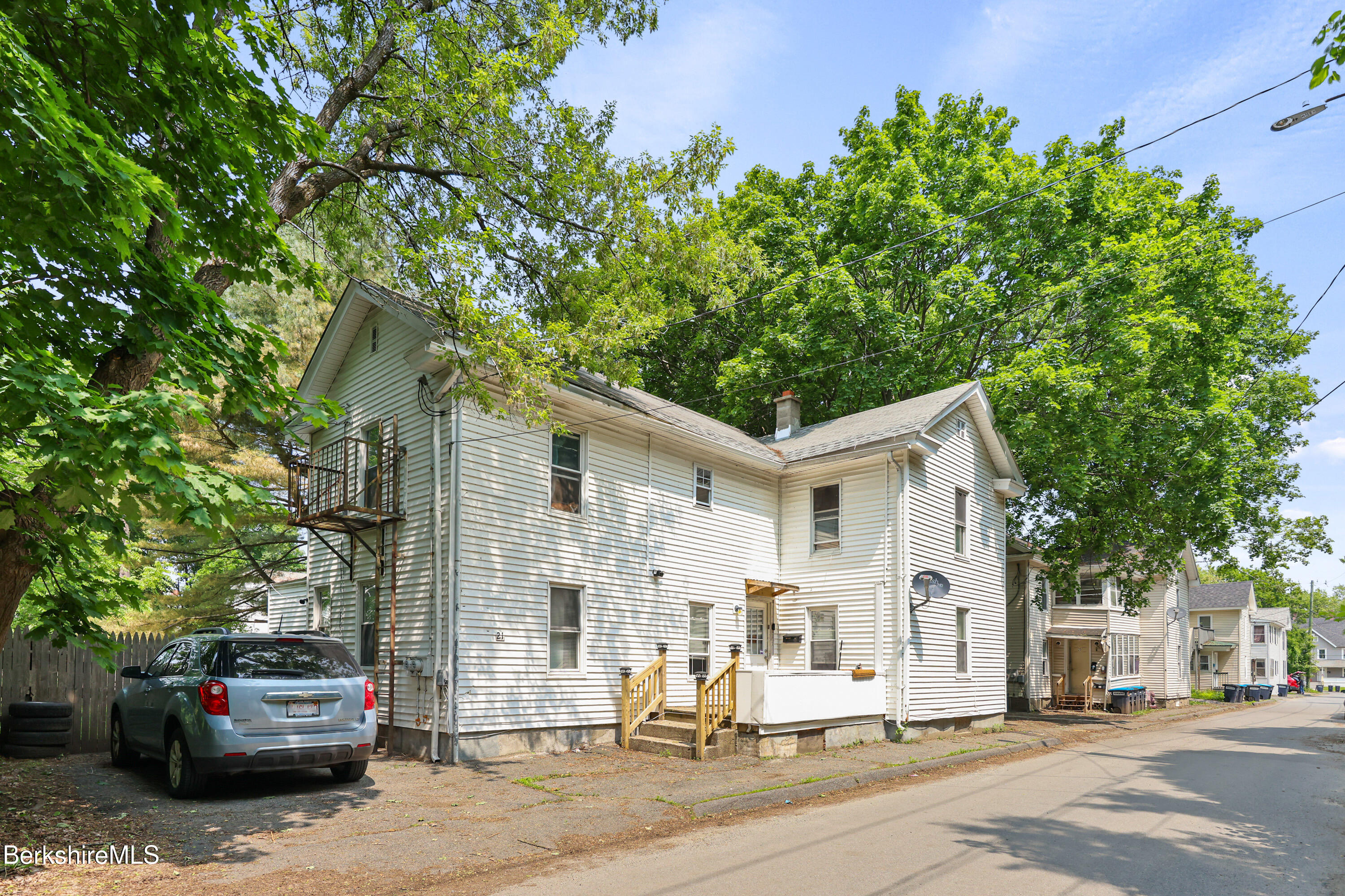a view of a white house with a outdoor space
