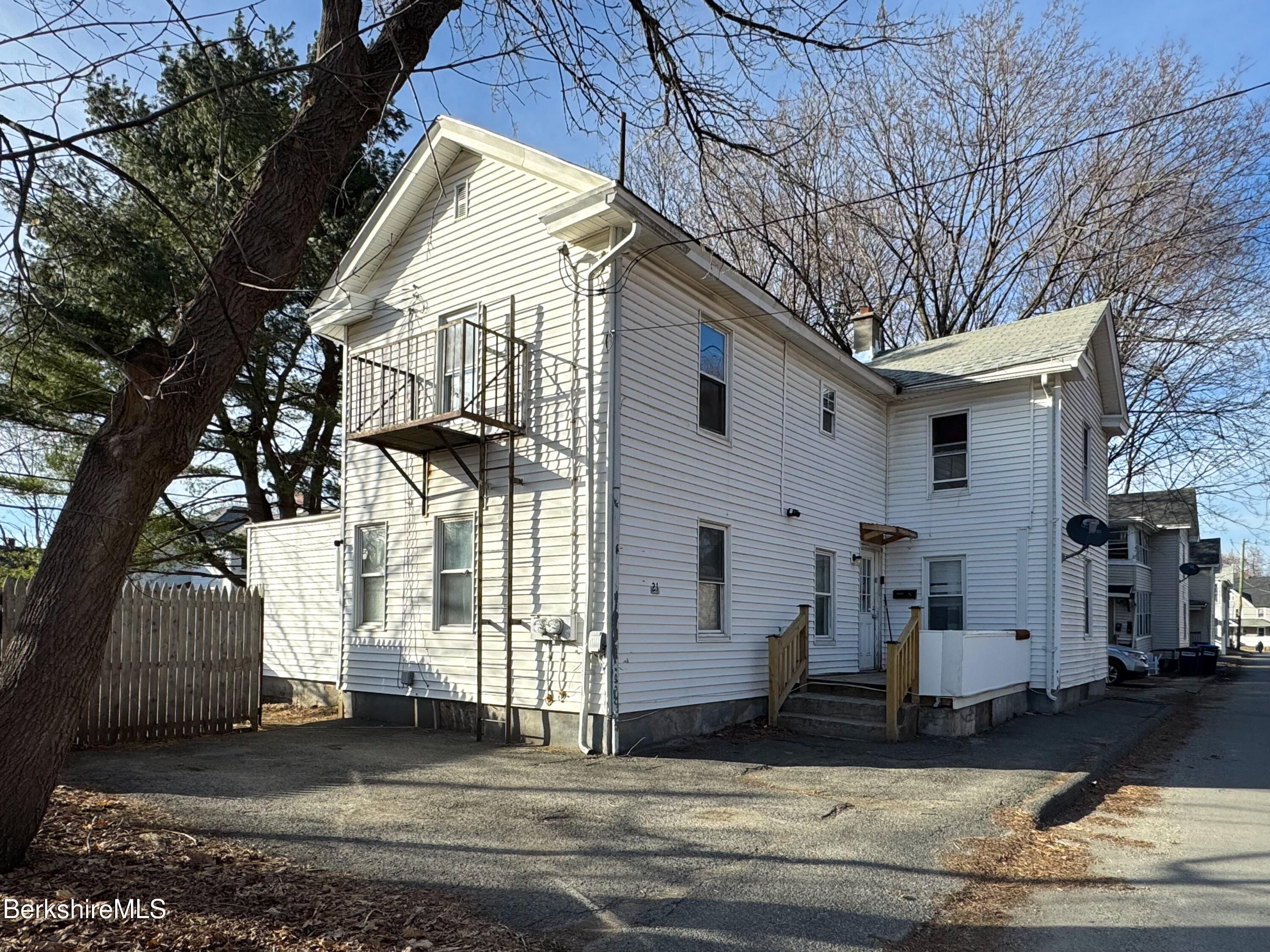 21 Pleasant Street Pittsfield, MA 01201 - Photo 13 of 16 a view of a white house with a large tree