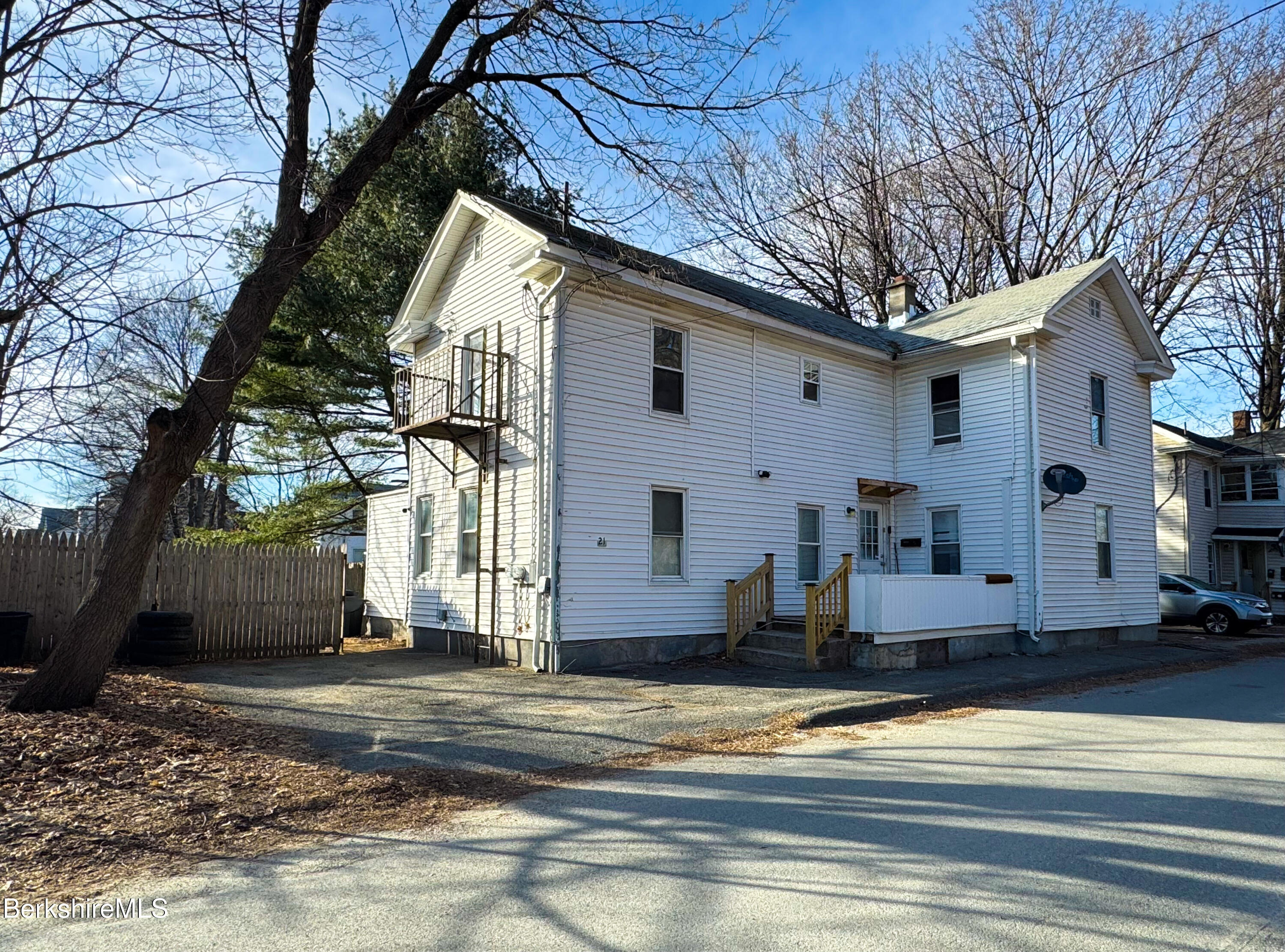 21 Pleasant Street Pittsfield, MA 01201 - Photo 14 of 16 a view of a white house with a large tree
