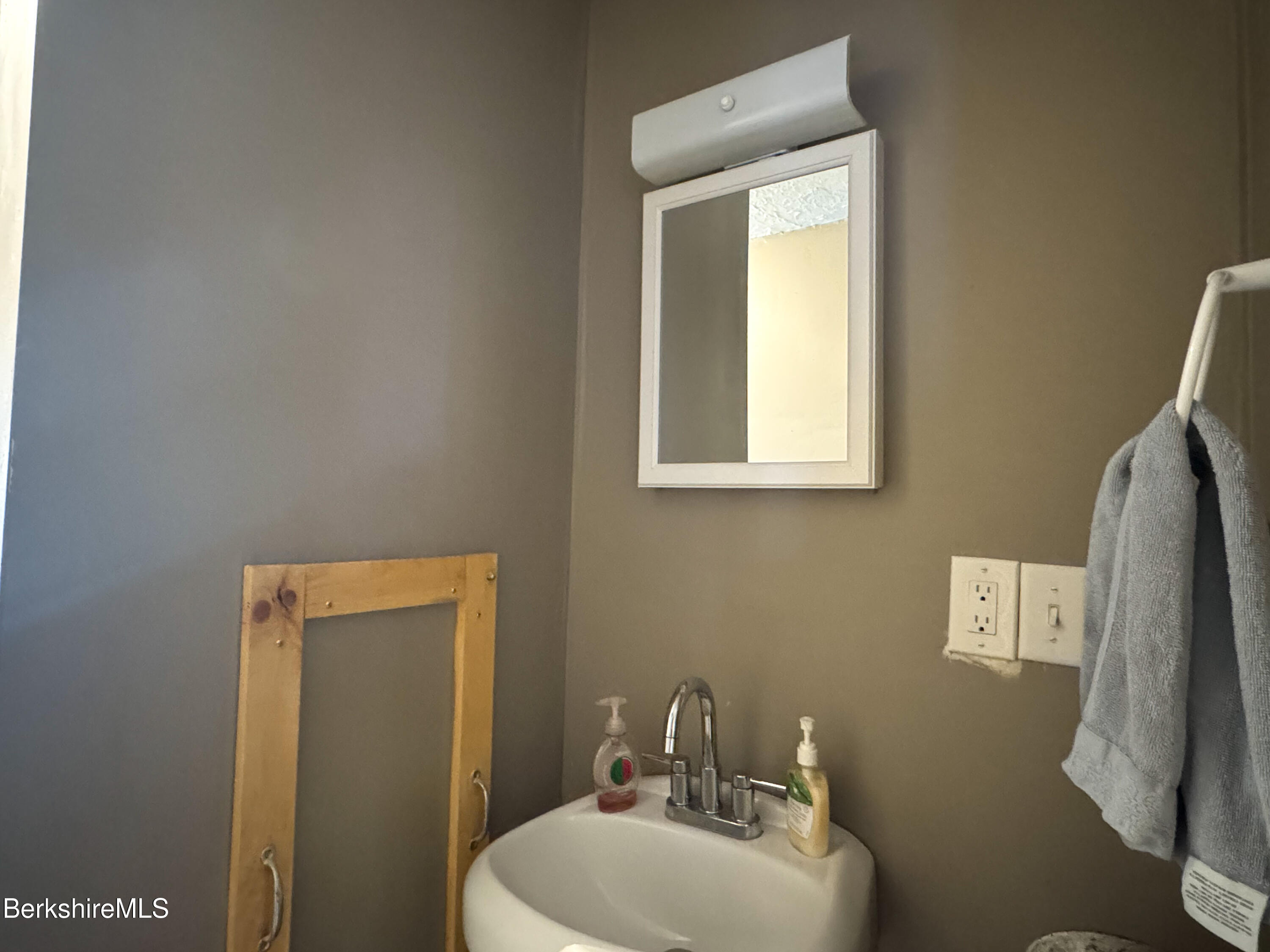 21 Pleasant Street Pittsfield, MA 01201 - Photo 4 of 16 a bathroom with a toilet sink and mirror