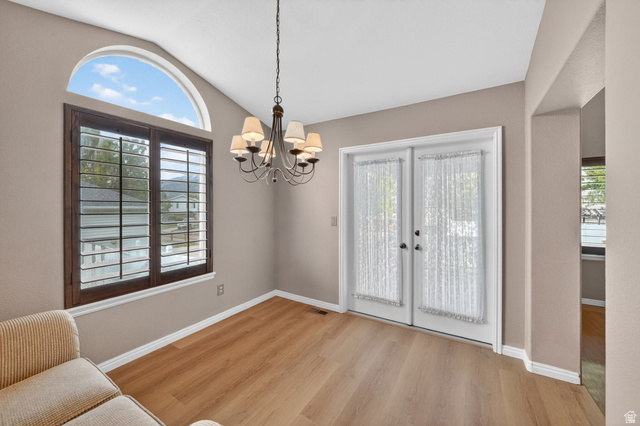 1464 990 West Provo, UT 84601 - Photo 7 of 41 Room with wood-finish flooring featuring a large window with plantation shutters and an arched transom window
