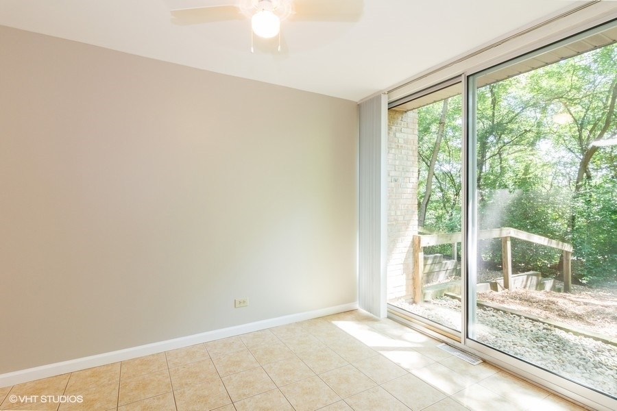 6008 Forest View Road, Unit 1D Lisle, IL 60532 - Photo 5 of 22 a view of an empty room and window