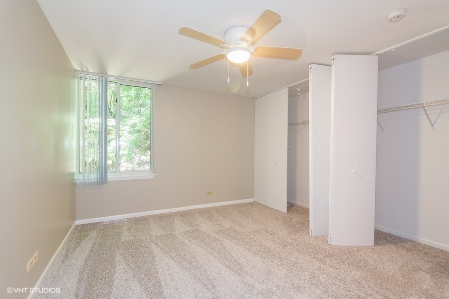 6008 Forest View Road, Unit 1D Lisle, IL 60532 - Photo 7 of 22 a view of an empty room with a window