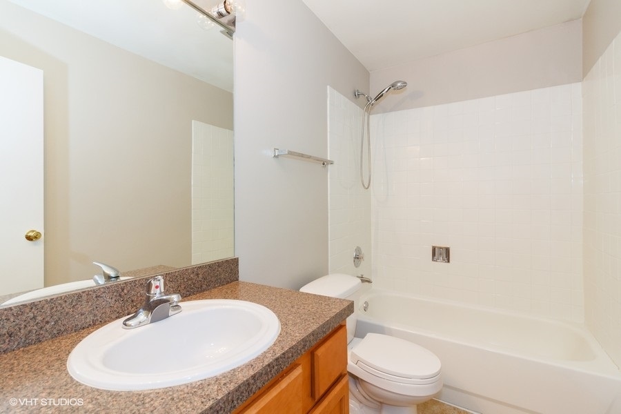6008 Forest View Road, Unit 1D Lisle, IL 60532 - Photo 8 of 22 a bathroom with a sink toilet and shower