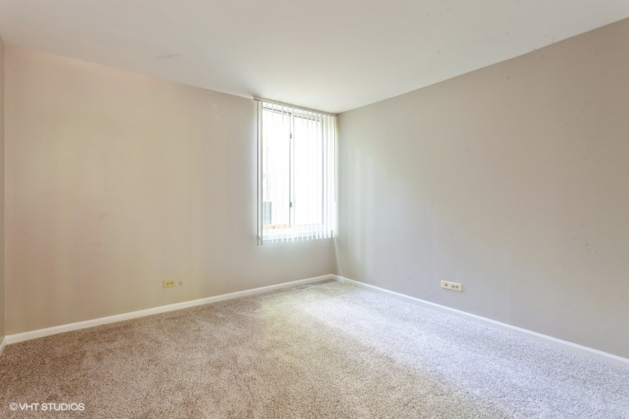 6008 Forest View Road, Unit 1D Lisle, IL 60532 - Photo 9 of 22 a view of an empty room with a window