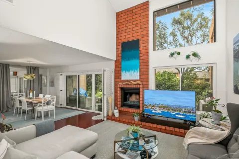a living room with furniture and a floor to ceiling window