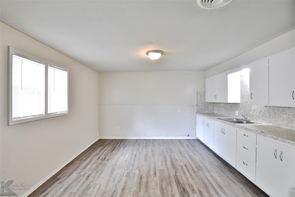 858 Beech Street Abilene, TX 79601 - Photo 14 of 24 a view of a kitchen with wooden floor and electronic appliances