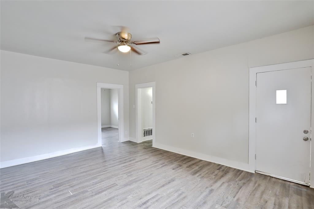 858 Beech Street Abilene, TX 79601 - Photo 15 of 24 an empty room with wooden floor and windows