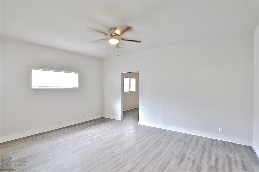 858 Beech Street Abilene, TX 79601 - Photo 16 of 24 an empty room with wooden floor and window