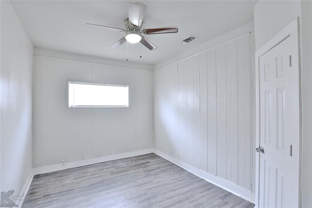 858 Beech Street Abilene, TX 79601 - Photo 19 of 24 an empty room with wooden floor and windows