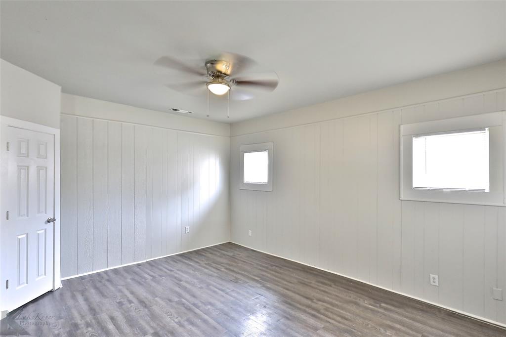 858 Beech Street Abilene, TX 79601 - Photo 4 of 24 an empty room with wooden floor and windows
