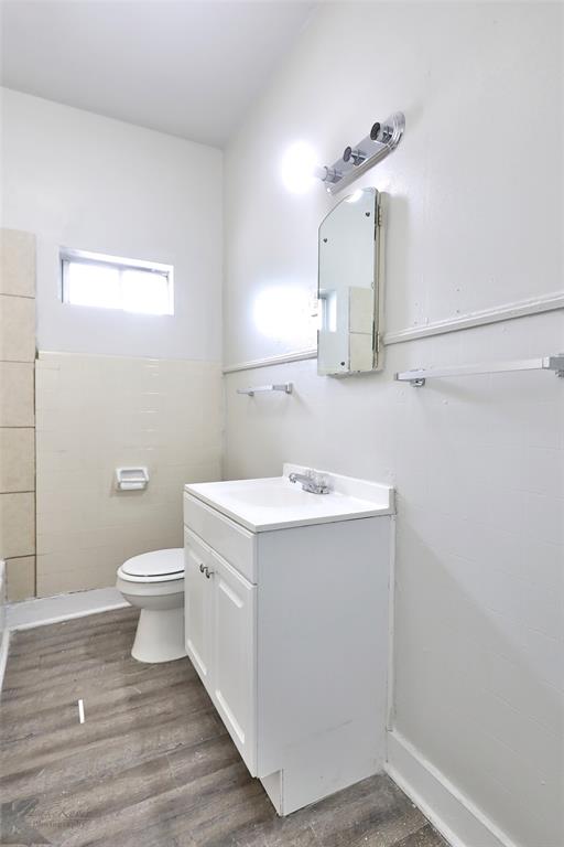 858 Beech Street Abilene, TX 79601 - Photo 8 of 24 a bathroom with a sink a toilet and mirror
