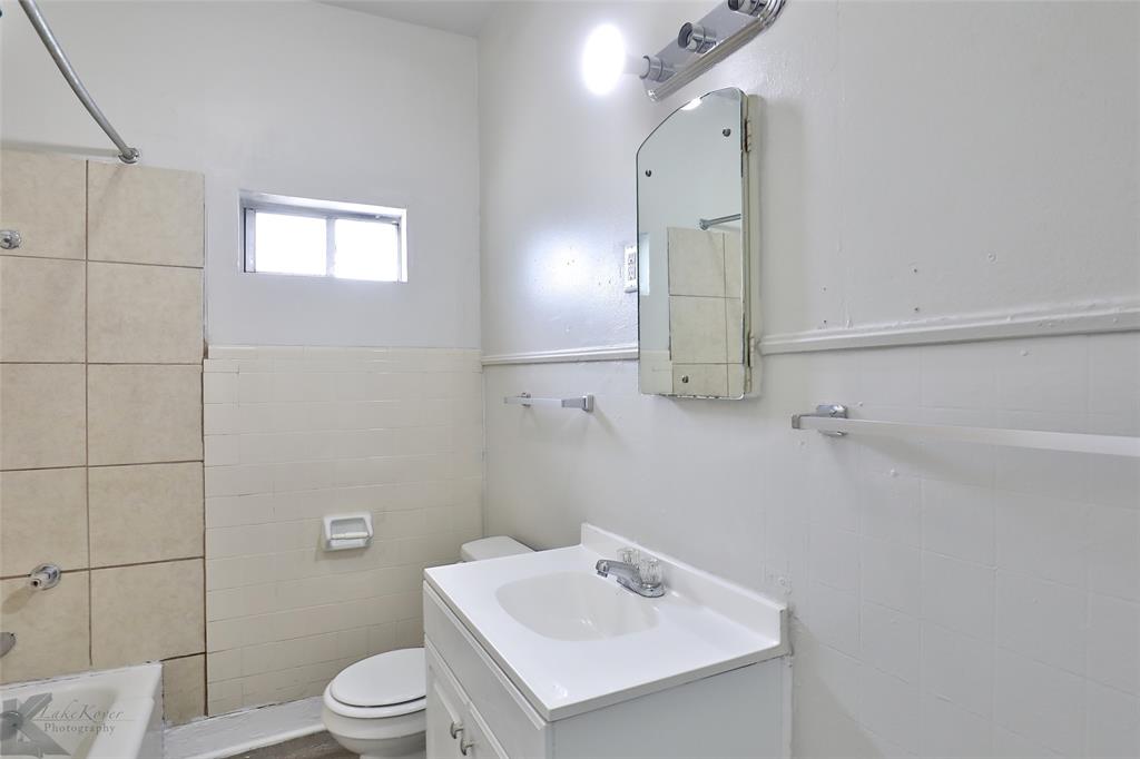 858 Beech Street Abilene, TX 79601 - Photo 9 of 24 a bathroom with a sink toilet and shower