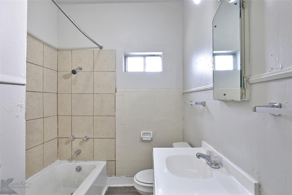 858 Beech Street Abilene, TX 79601 - Photo 10 of 24 a bathroom with a sink toilet and shower