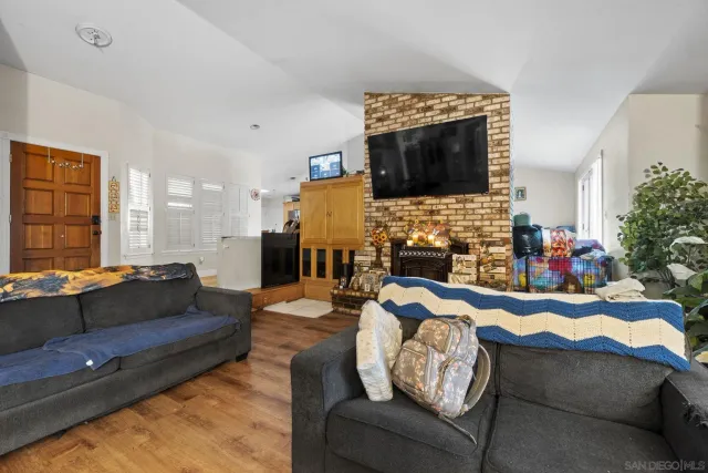 a living room with fireplace furniture and a flat screen tv