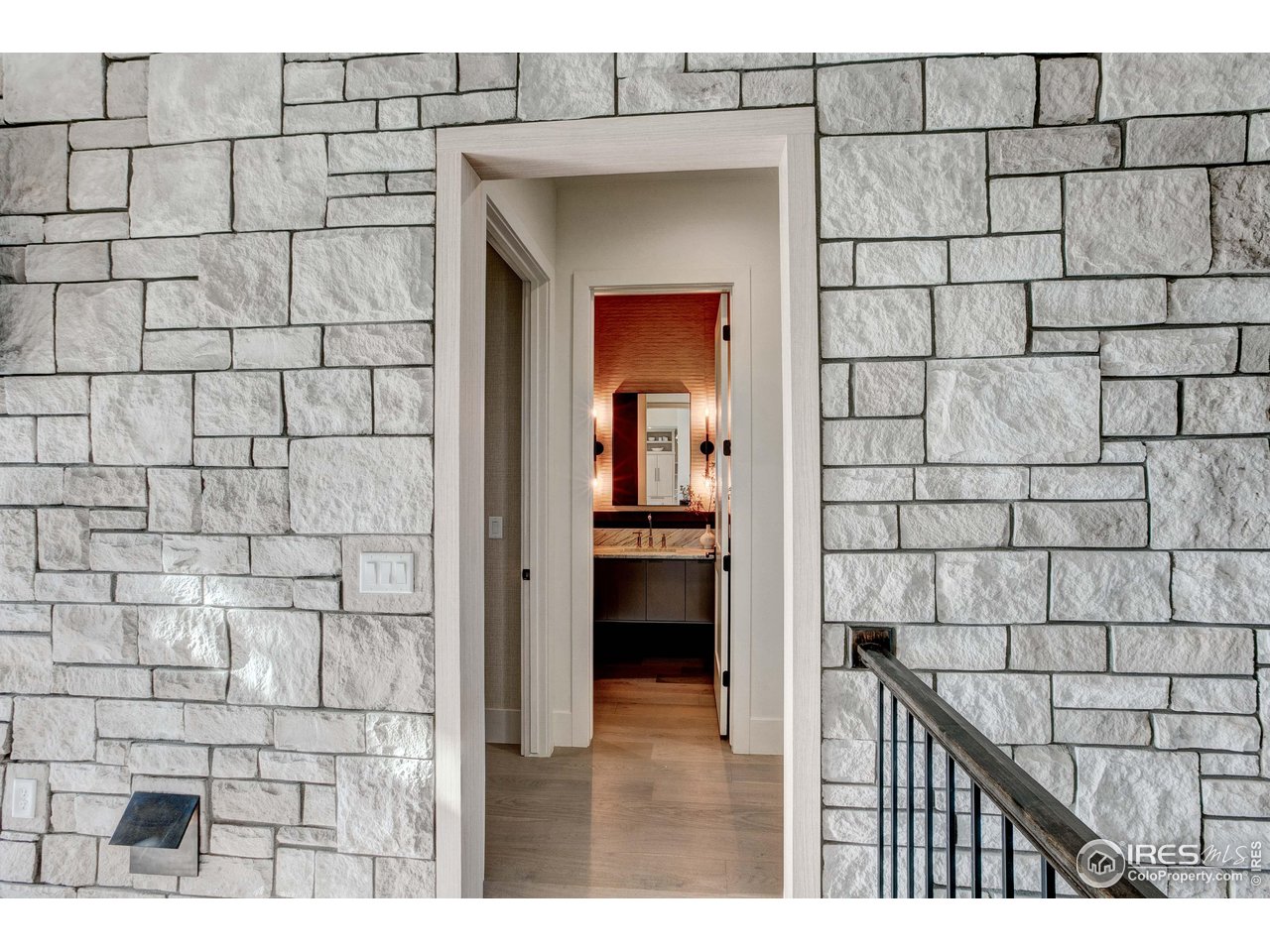 2517 Southwind Road Berthoud, CO 80513 - Photo 15 of 50 An elegant stone-accented entryway leads to the bedroom hallway, offering a beautifully defined transition between gathering spaces and private retreats