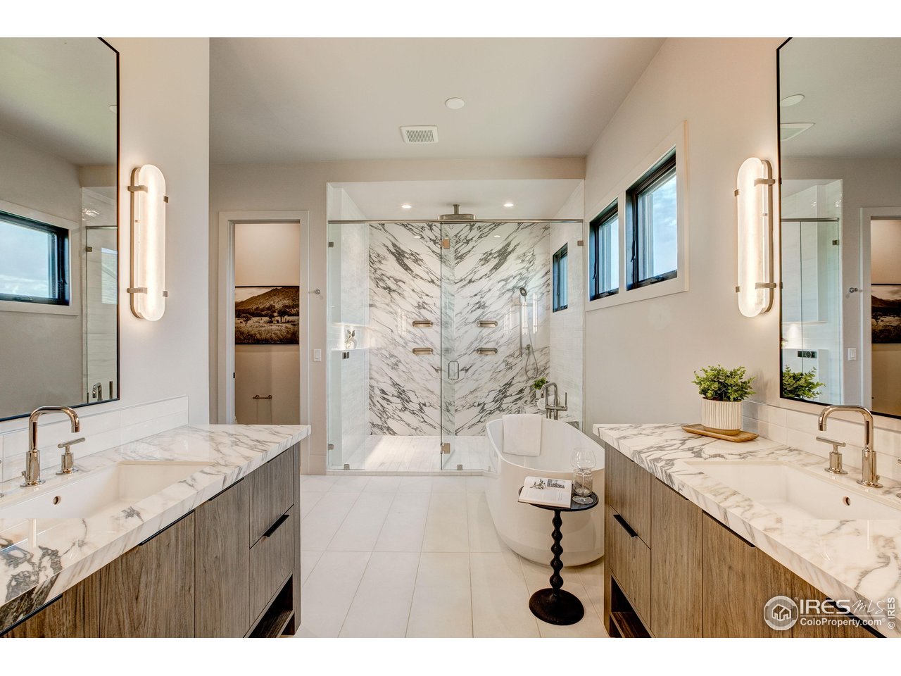 2517 Southwind Road Berthoud, CO 80513 - Photo 17 of 50 The primary bath showcases an expansive walk-in shower, thoughtfully designed with multiple jets and shower heads for a refined, hotel-quality experience