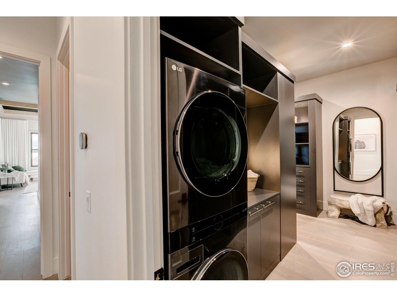 2517 Southwind Road Berthoud, CO 80513 - Photo 18 of 50 A discreet, stackable washer and dryer are seamlessly integrated into the primary closet, offering effortless daily convenience without compromising elegance