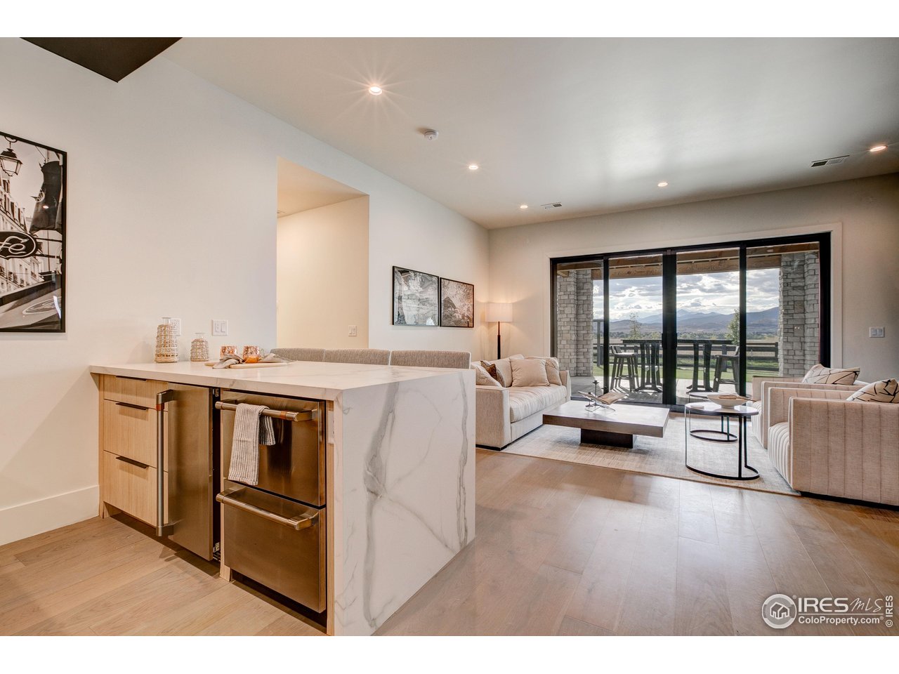 2517 Southwind Road Berthoud, CO 80513 - Photo 21 of 50 The lower level features a fully equipped wet bar with ice maker, beverage cooler, dishwasher, and sink, designed for effortless entertaining and elevated gatherings