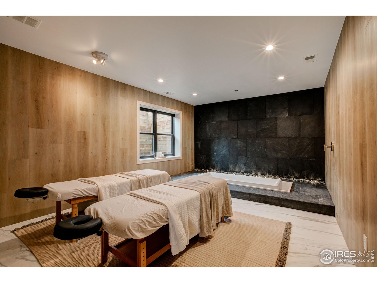 2517 Southwind Road Berthoud, CO 80513 - Photo 30 of 50 Restore health in the built-in, sunken chromotherapy tub framed by stone for a calming, grotto-inspired atmosphere. Add in-home massage to complete this elevated wellness experience.