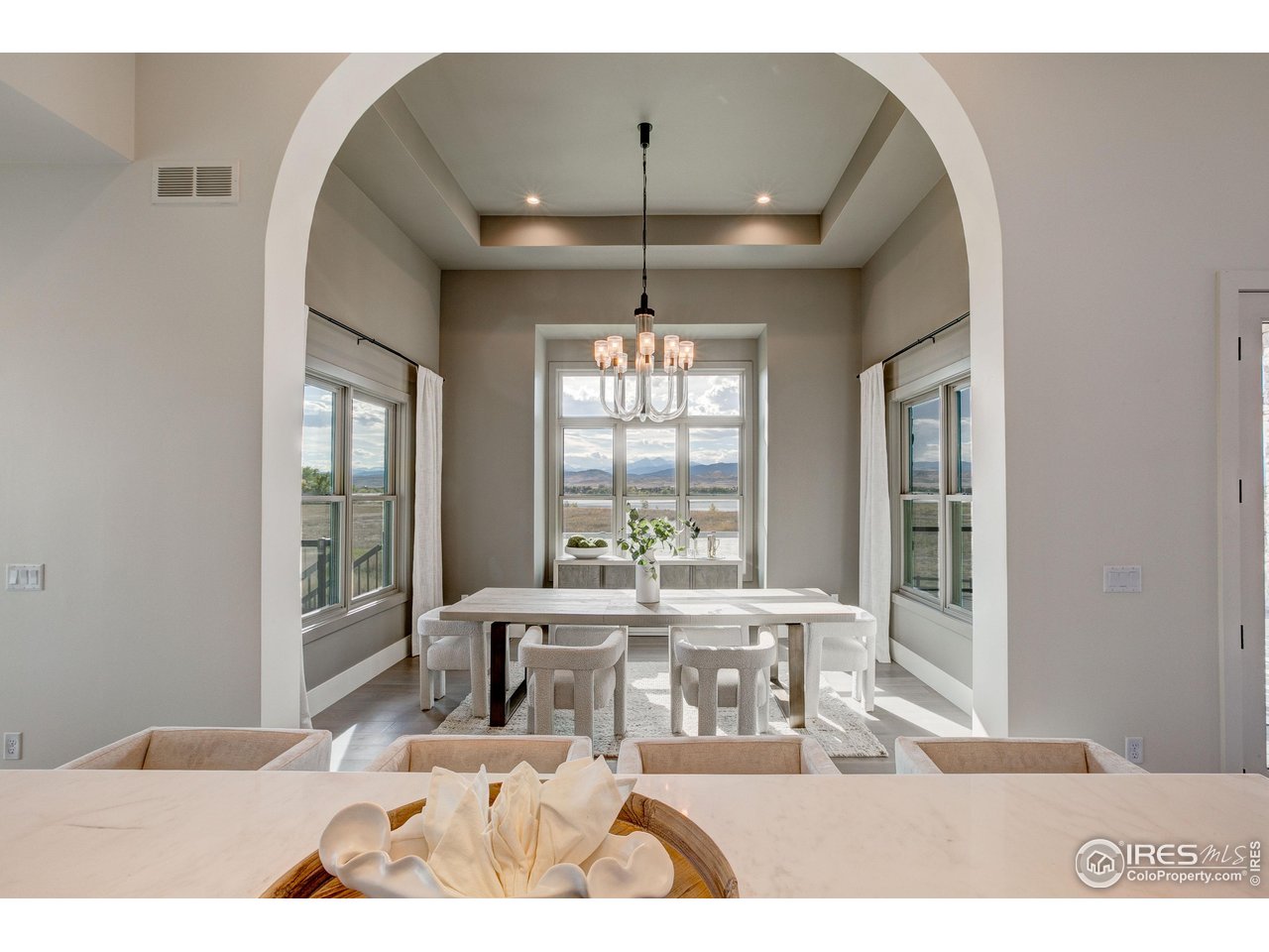 2517 Southwind Road Berthoud, CO 80513 - Photo 9 of 50 Separate dining room from the kitchen creates a dedicated space to entertain and take in the incredible views of Lone Tree Reservoir & the mountains.