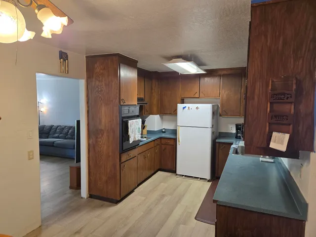 a kitchen with refrigerator and microwave