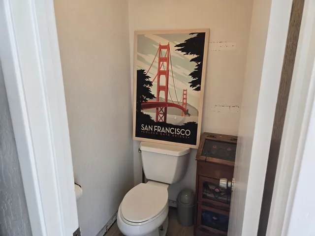 a white toilet sitting next to a bathroom sink