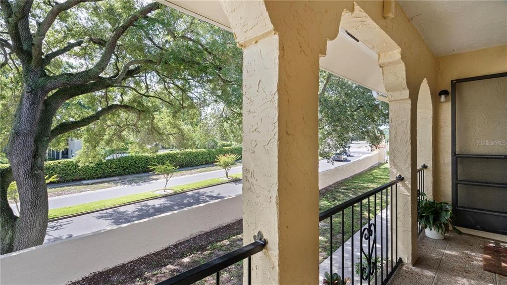 106 West San Sebastian Court, Unit 106 Altamonte Springs, FL 32714 - Photo 2 of 11 a view of a wooden balcony with a tree