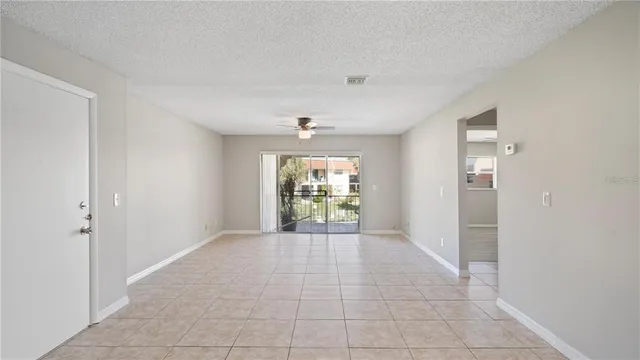 a view of an empty room with window and cabinet