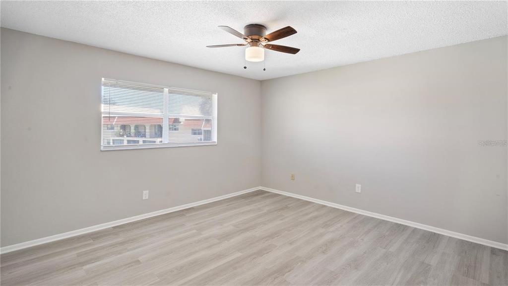 106 West San Sebastian Court, Unit 106 Altamonte Springs, FL 32714 - Photo 7 of 11 wooden floor in an empty room with a window