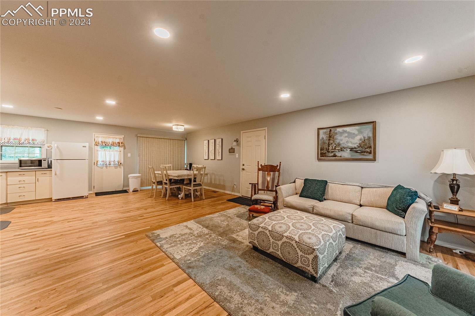 1407 Alexander Road Colorado Springs, CO 80909 - Photo 2 of 27 Living room with light hardwood / wood-style flooring