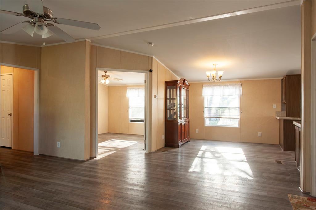 112 Southeast Front Street Bailey, TX 75452 - Photo 4 of 38 a view of an empty room with window and wooden floor