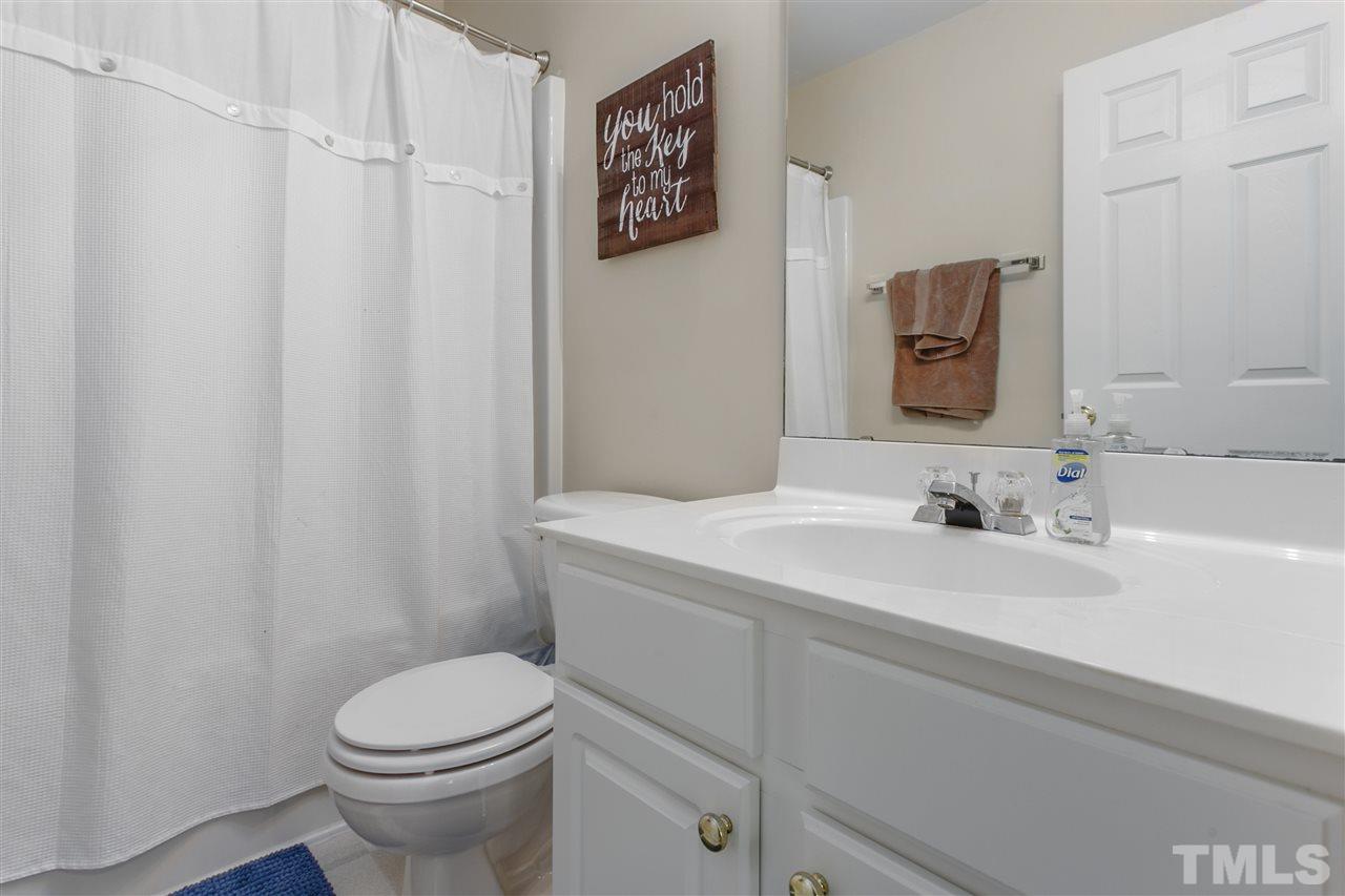 5505 Red Robin Road Raleigh, NC 27613 - Photo 12 of 19 a bathroom with a sink a toilet and a mirror