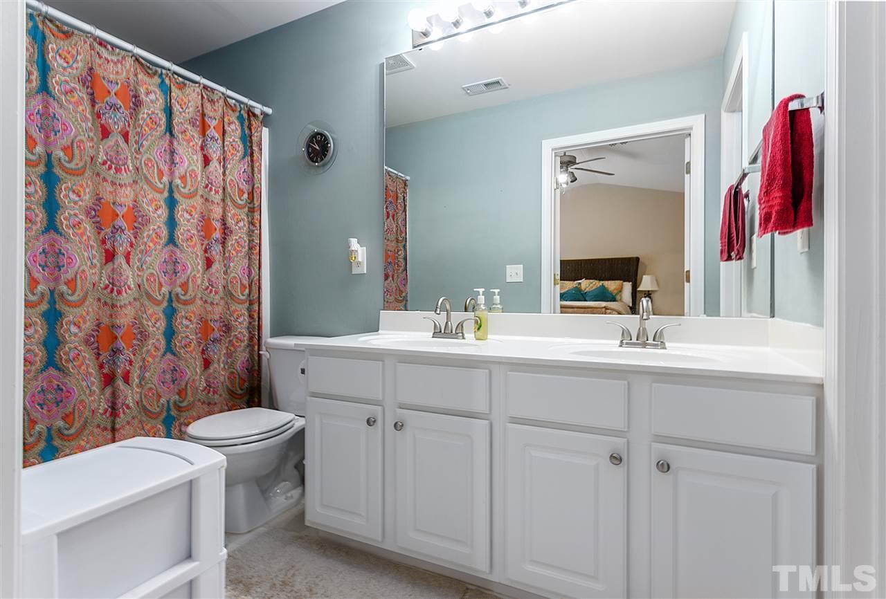 5505 Red Robin Road Raleigh, NC 27613 - Photo 13 of 19 a bathroom with a sink and a mirror