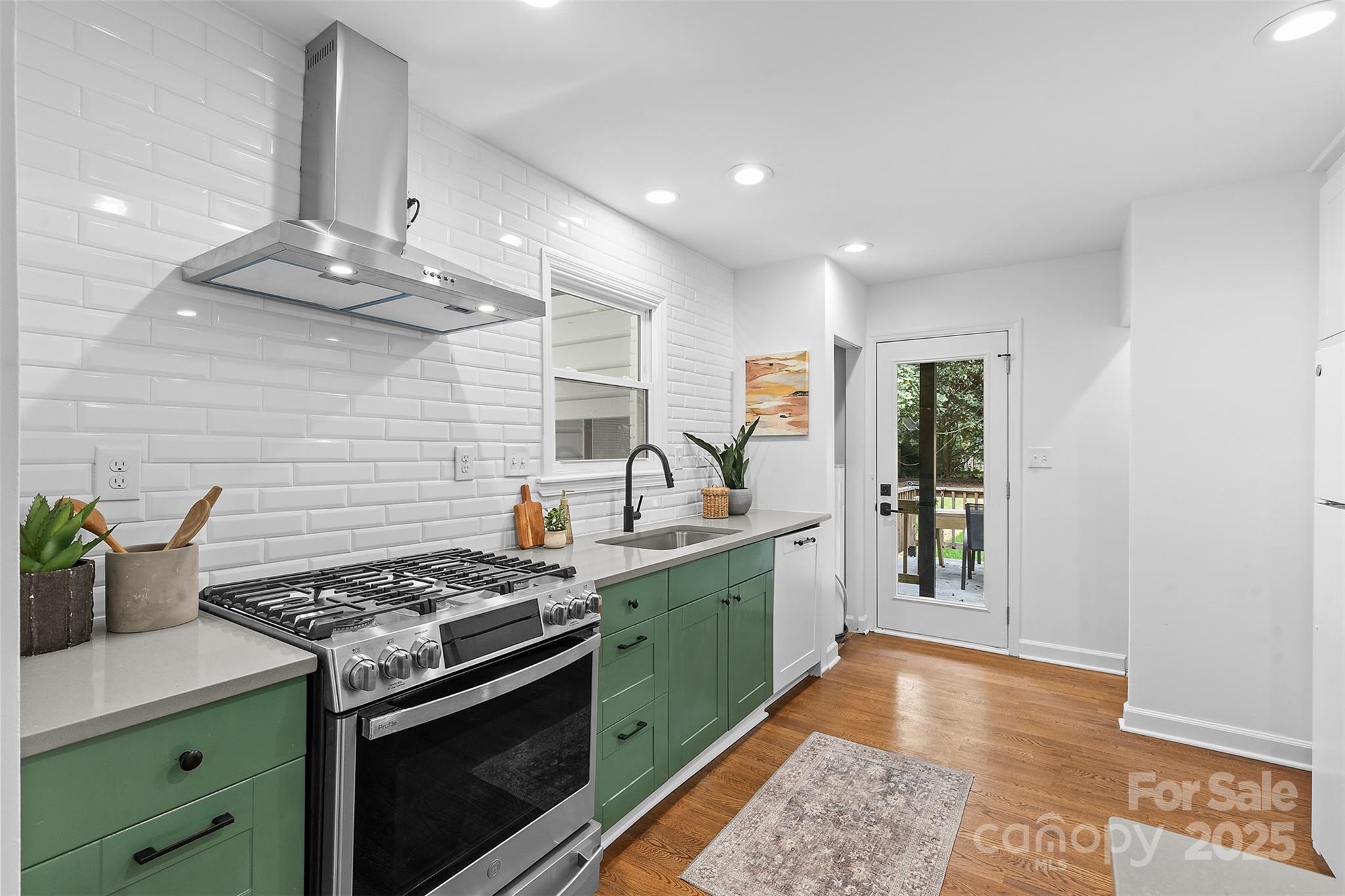 917 Scaleybark Road Charlotte, NC 28209 - Photo 13 of 42 a kitchen with stainless steel appliances granite countertop a stove a sink and a refrigerator