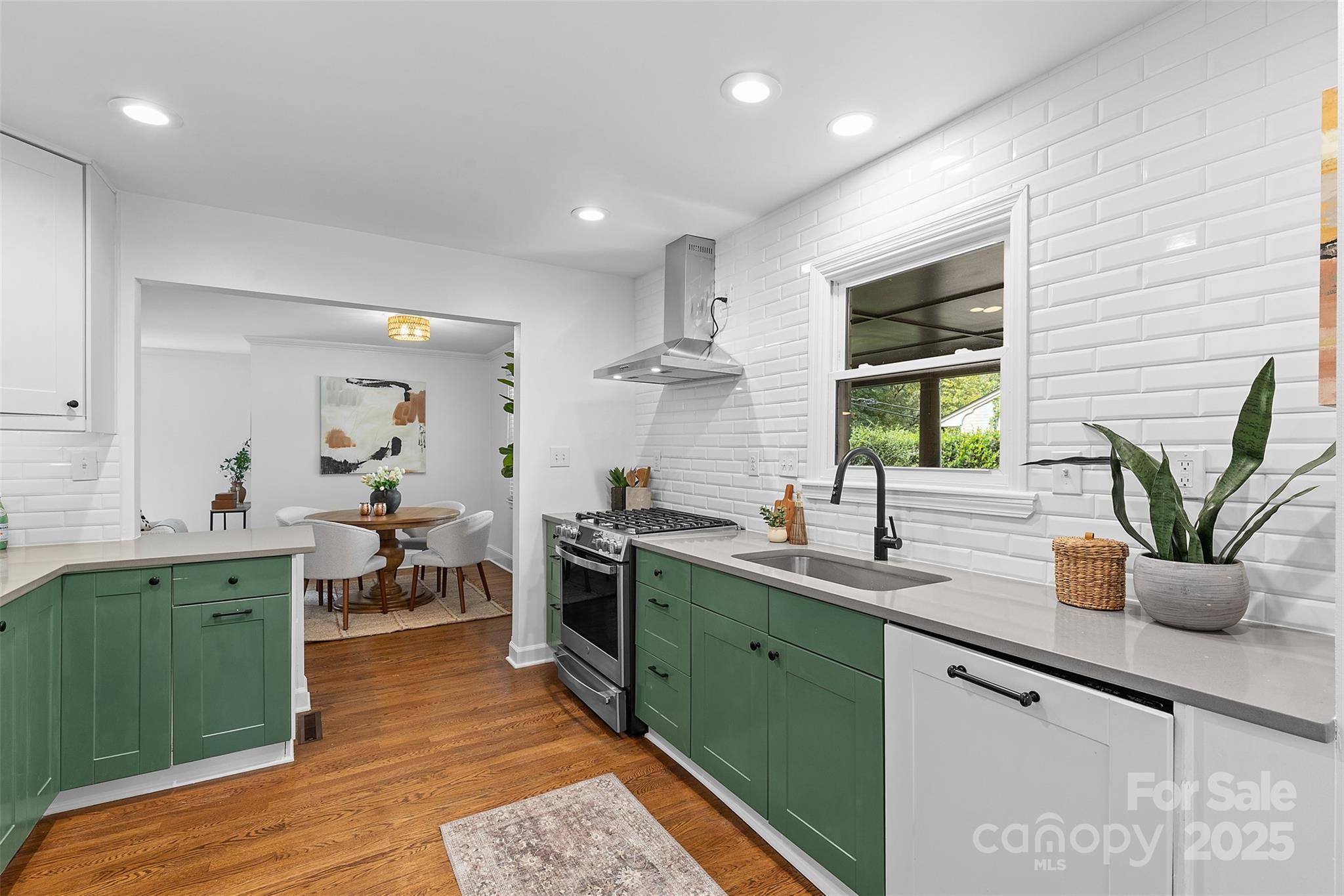 917 Scaleybark Road Charlotte, NC 28209 - Photo 18 of 42 a kitchen with lots of counter space sink and wooden floor