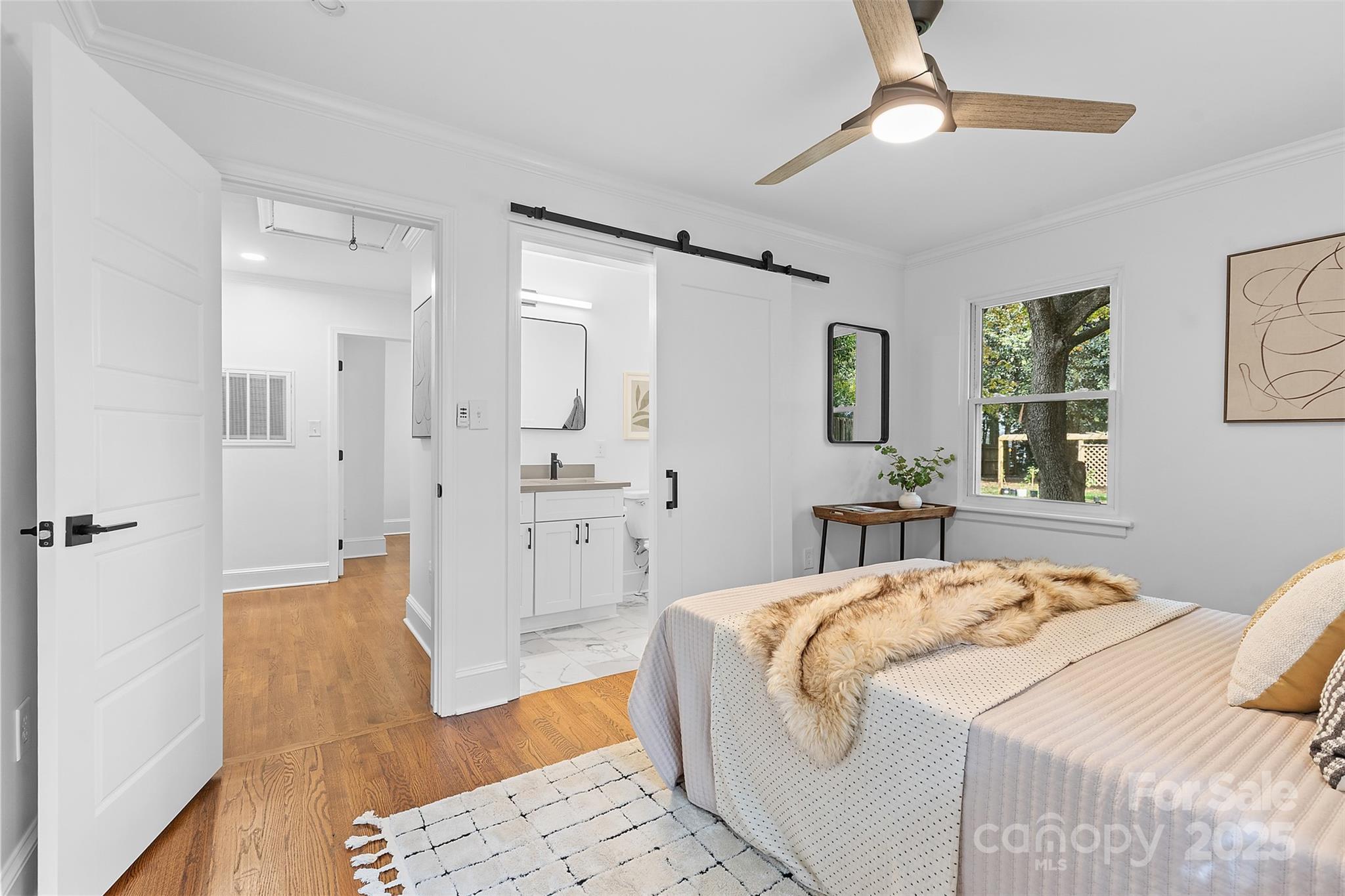 917 Scaleybark Road Charlotte, NC 28209 - Photo 20 of 42 a bedroom with a bed and a chandelier