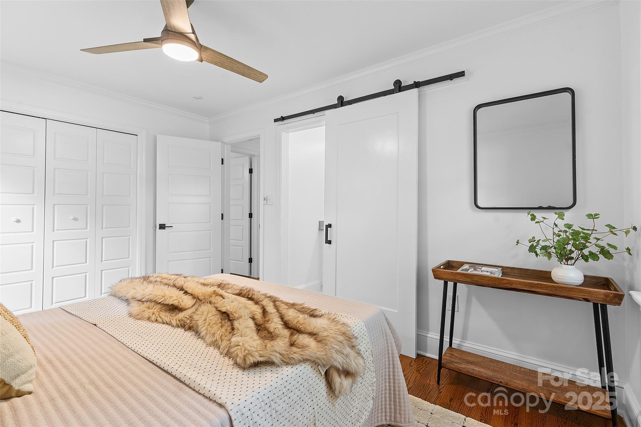 917 Scaleybark Road Charlotte, NC 28209 - Photo 21 of 42 a bedroom with a bed chandelier and a window