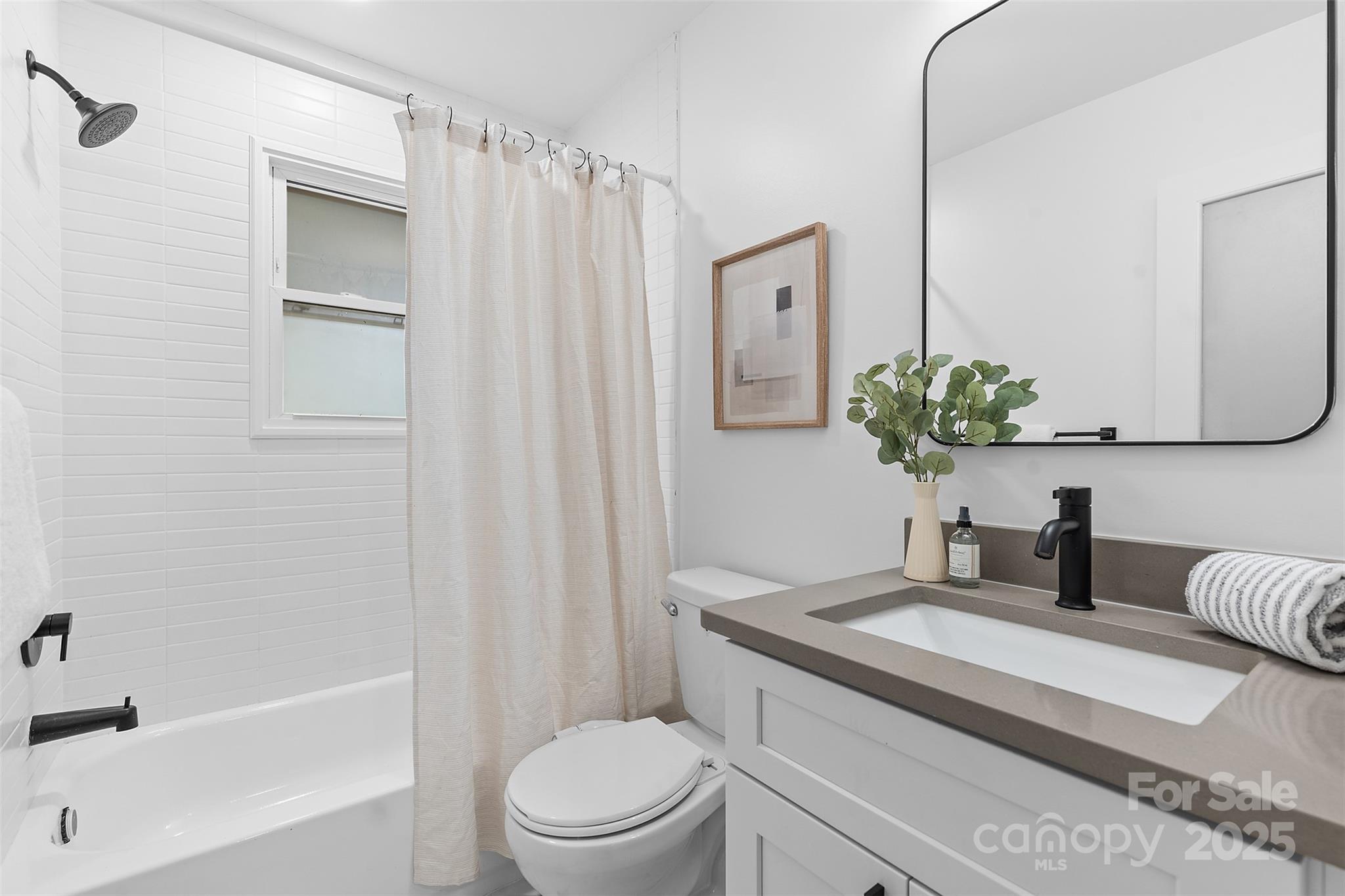 917 Scaleybark Road Charlotte, NC 28209 - Photo 28 of 42 a bathroom with a granite countertop sink toilet and shower